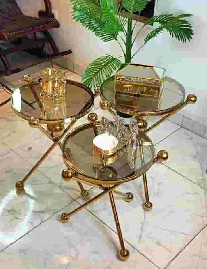 A set of 3-piece stainless round tables