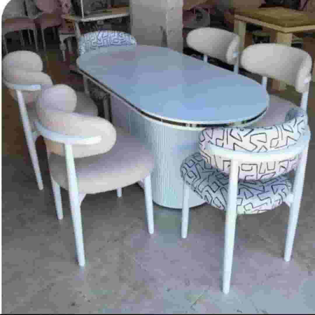 A red beech wood table and the disc is 6 in a heavy carpentry chair